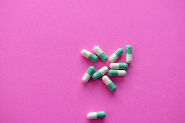 photo of pills over a light pink background
